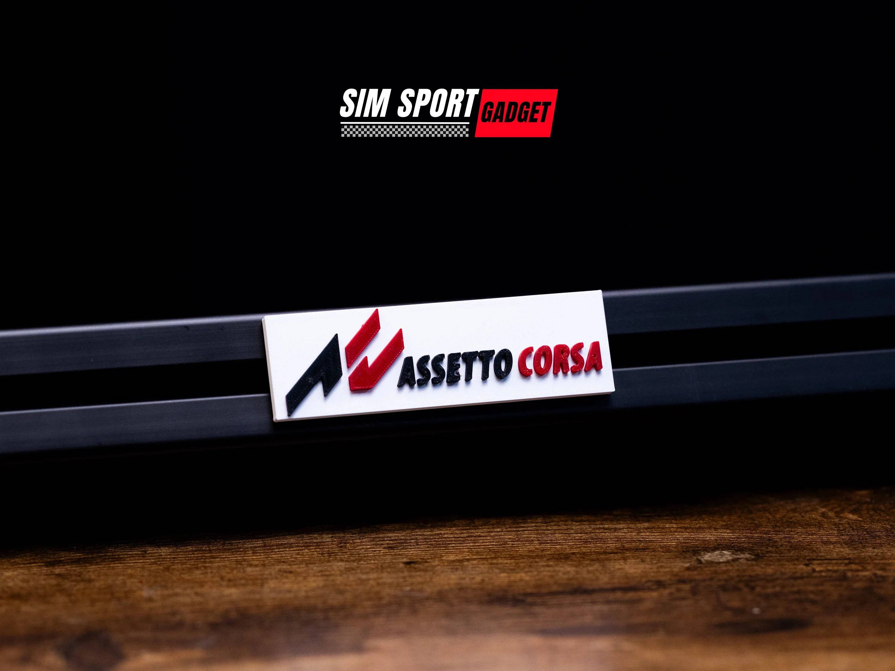 SimSportGadget Assetto Corsa 3D logo art decor for sim racing, featuring a sleek, illuminated racing game emblem on a black background.