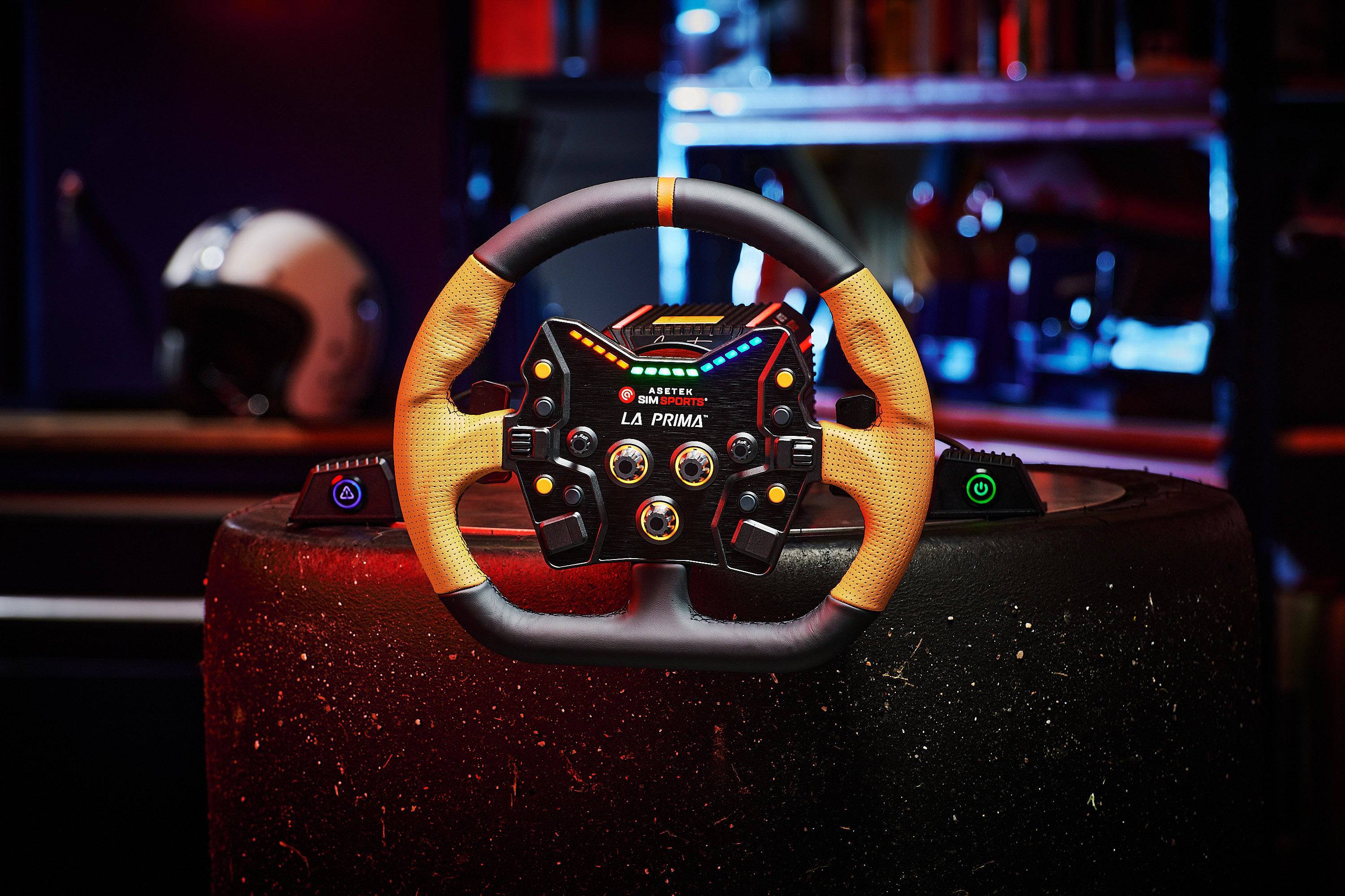 Asetek SimSports La Prima button box with black leather rim, orange center stripe, and perforated leather handles for racing wheel accessories.