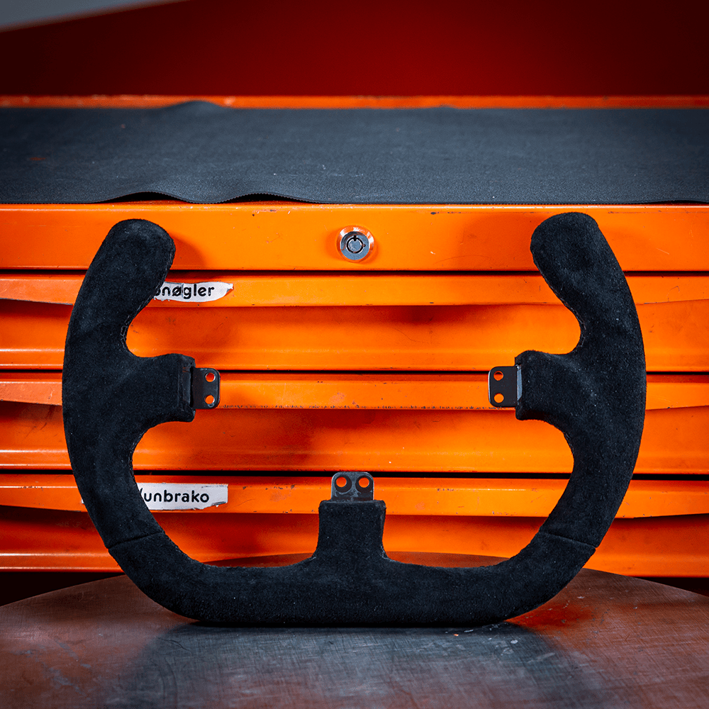 Asetek SimSports GT wheel rim with open D suede design, black finish, for sim racing setups.