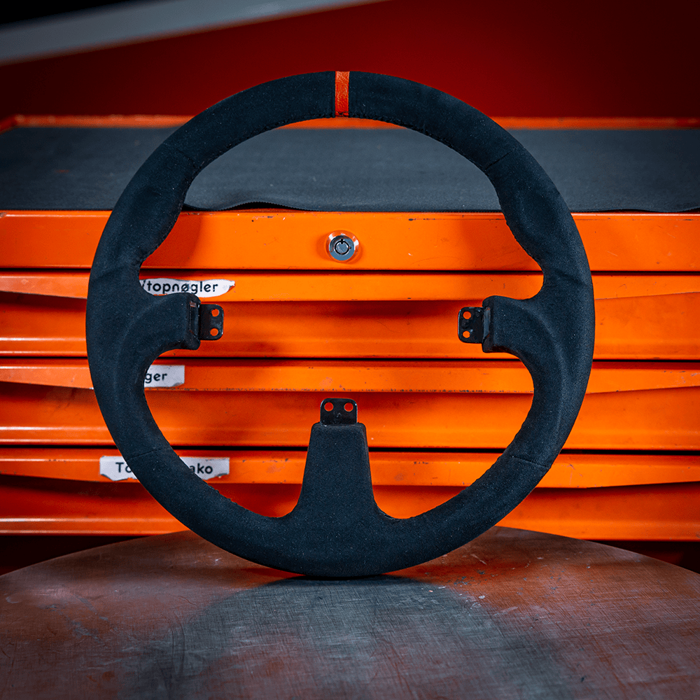 Asetek SimSports GT Rim wheel rim accessory in black with a red center stripe, designed for sim racing with round comfort grip.