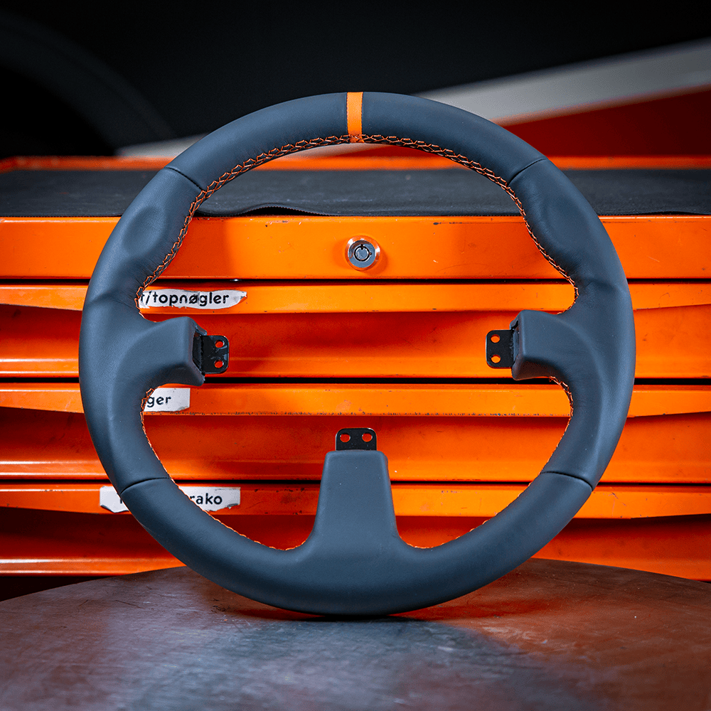 Asetek SimSports Wheel GT Rim with round black leather design and orange center stripe, car racing wheel rim accessory.