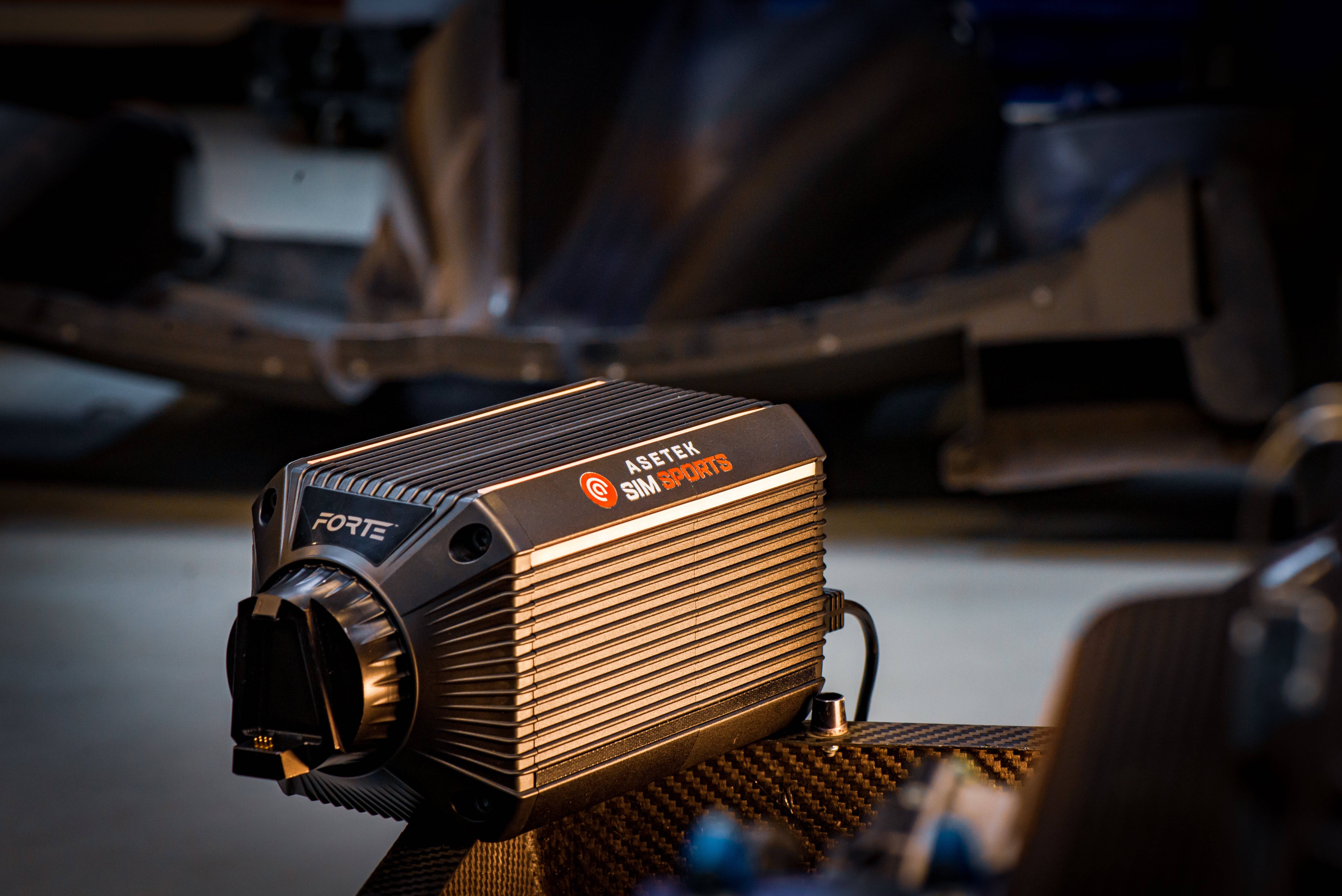 Asetek SimSports Forte Direct Drive Wheelbase 18Nm with sleek black design and control buttons on top, used for racing simulations.