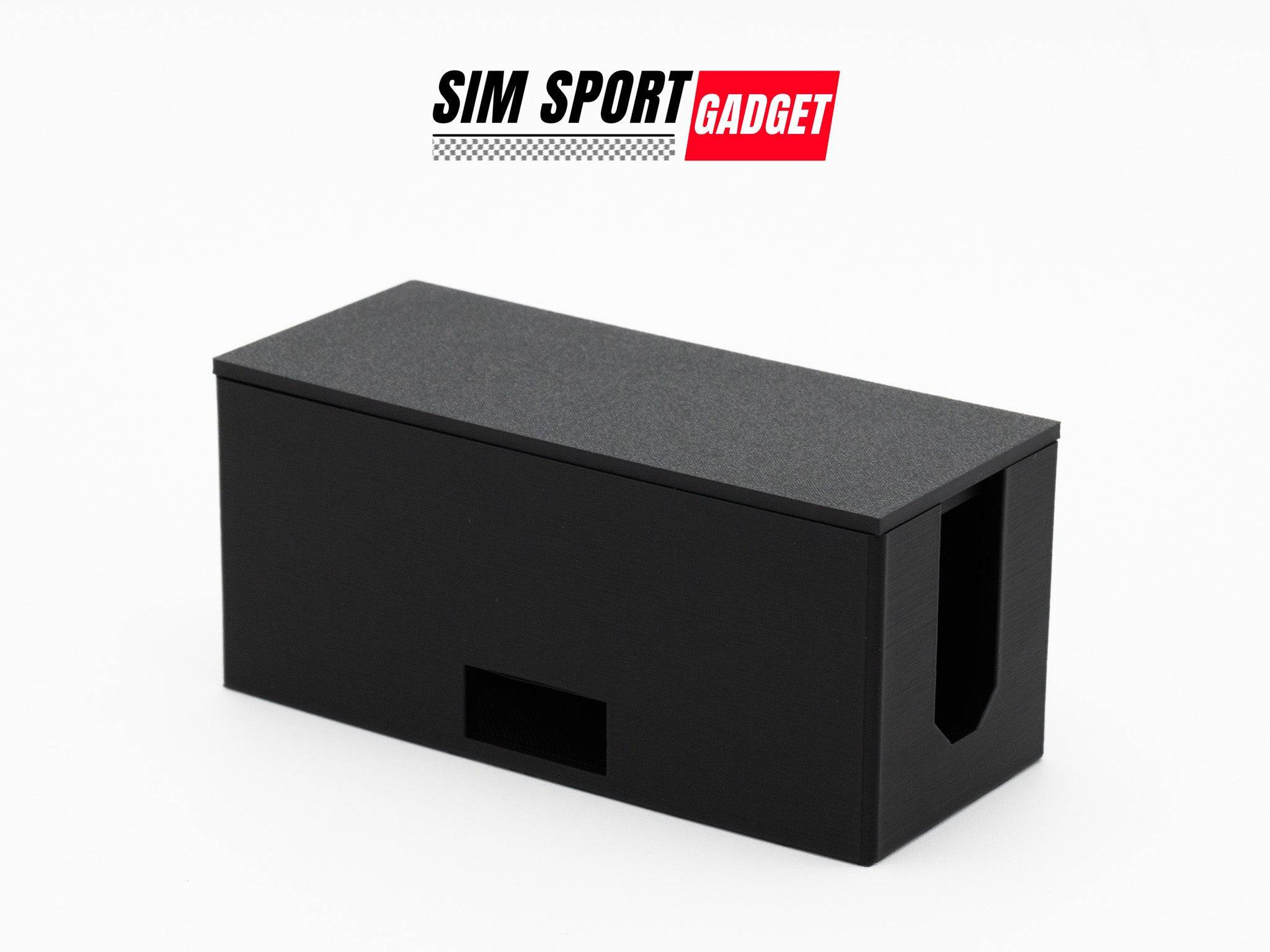 SimSportGadget cable management box for sim racing setup, organizing cables neatly and reducing clutter in gaming space.