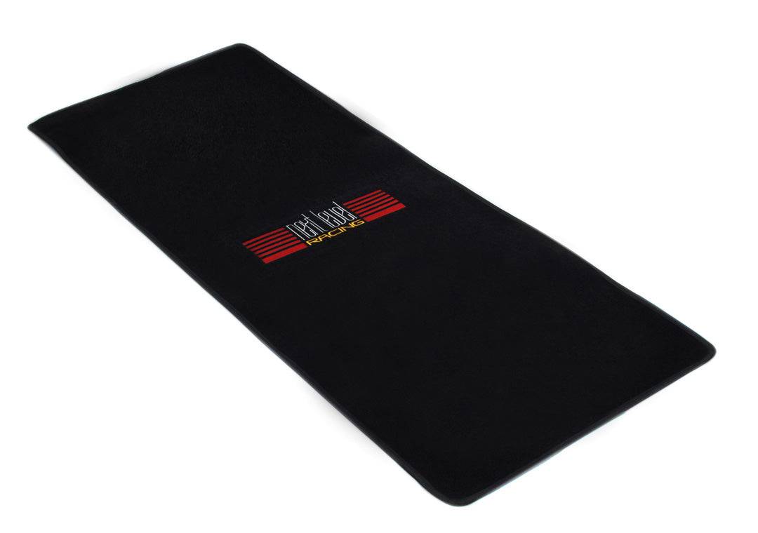 Next Level Racing Floor Mat accessory in black, designed to protect flooring and provide stable footing during gaming sessions