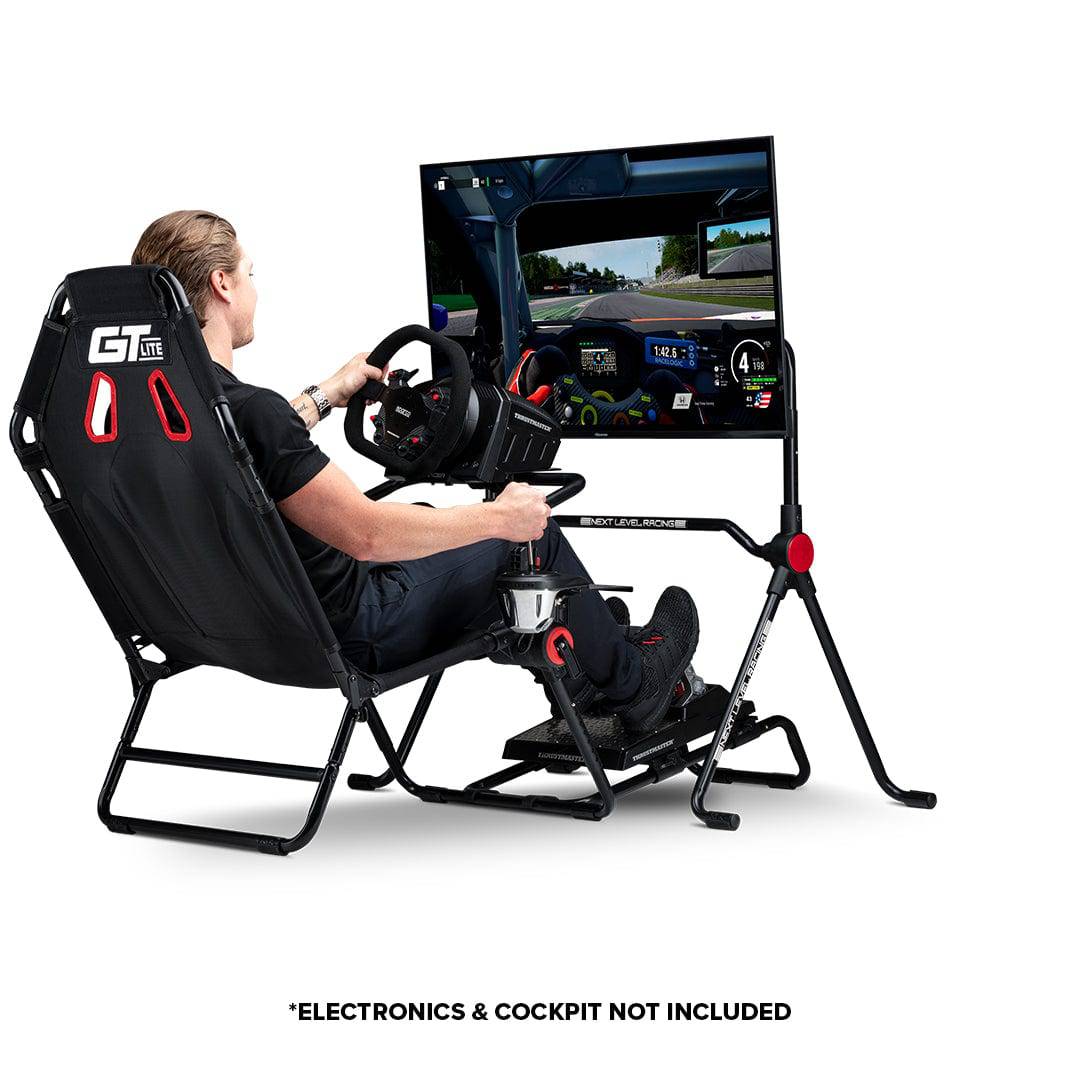 Next Level Racing Lite free-standing monitor stand supporting multiple screens, black metal design with adjustable arms.