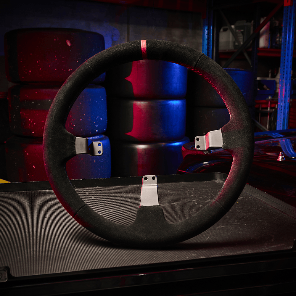 Asetek SimSports Dished Suede Rim wheel rim for racing simulators, shown in a rally-drift environment setting.