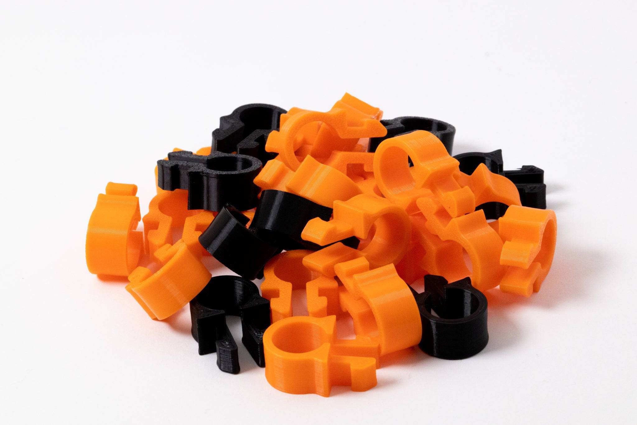 SimSportGadget SNUG Cable Management Clip securing cables neatly in black plastic for organized wiring.