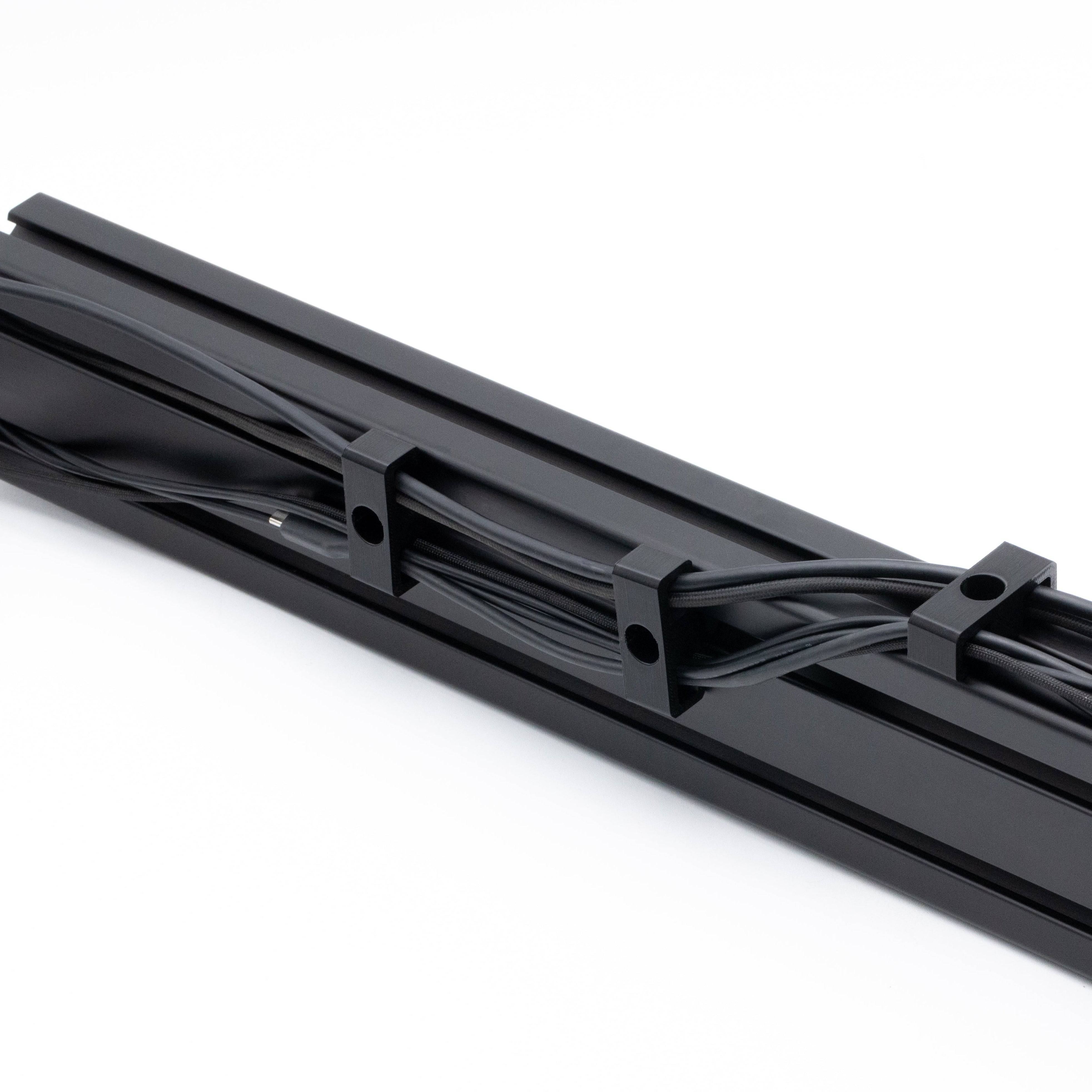 SimSportGadget bolt-in cable management clips for organizing and securing cables in various applications.