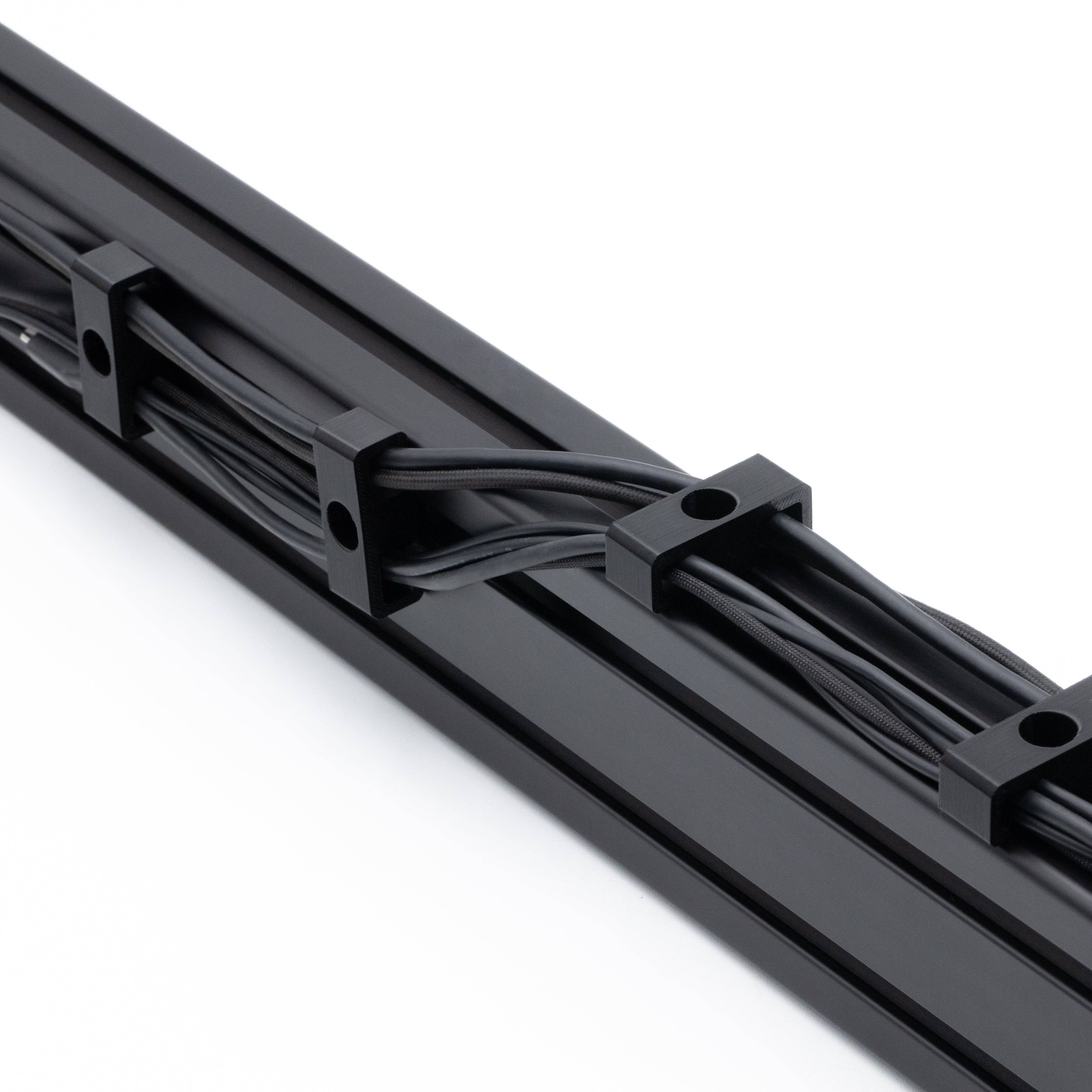SimSportGadget bolt-in style cable management clips for organizing cables securely and neatly in various setups.