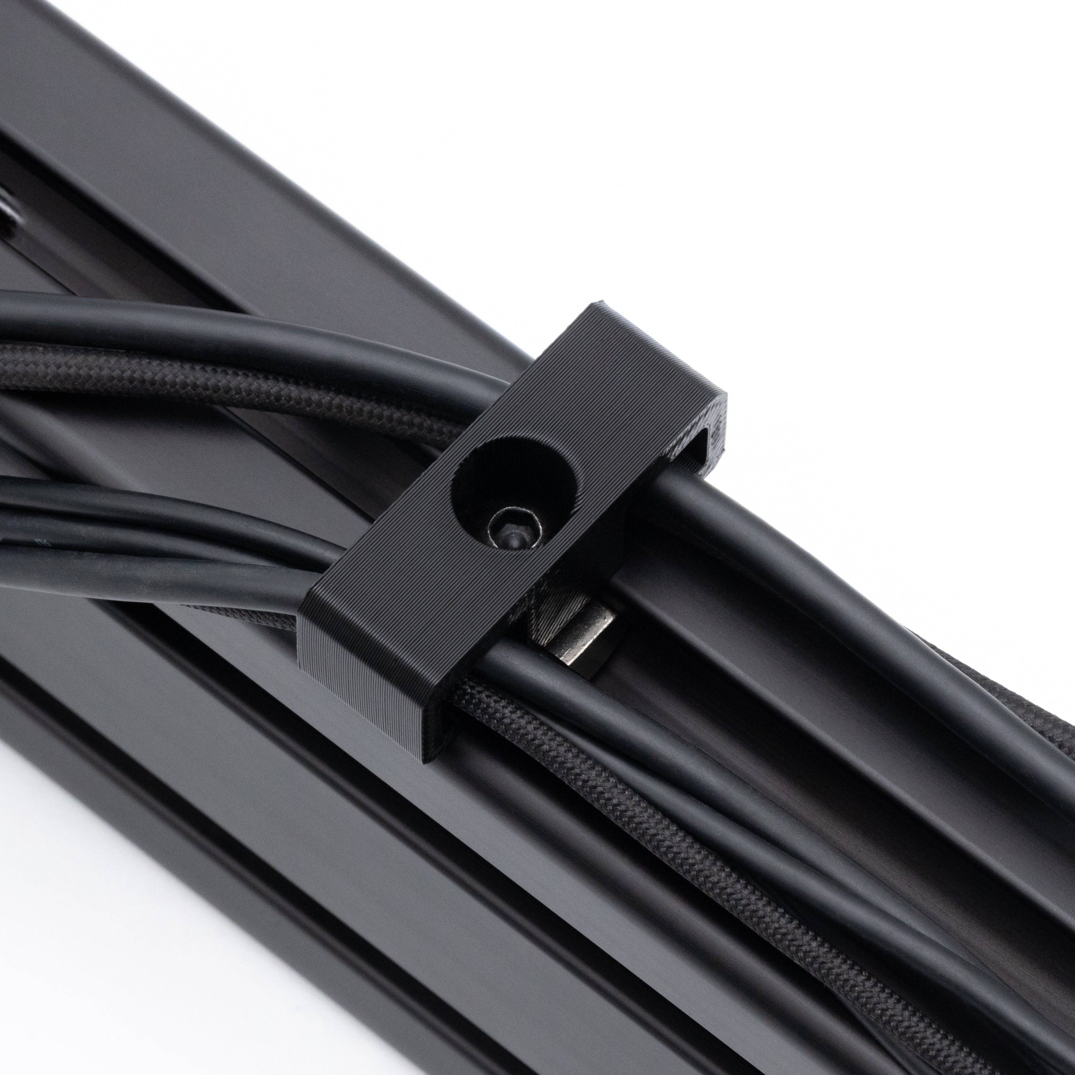 SimSportGadget bolt-in style cable management clip securing cables neatly in a professional setup.