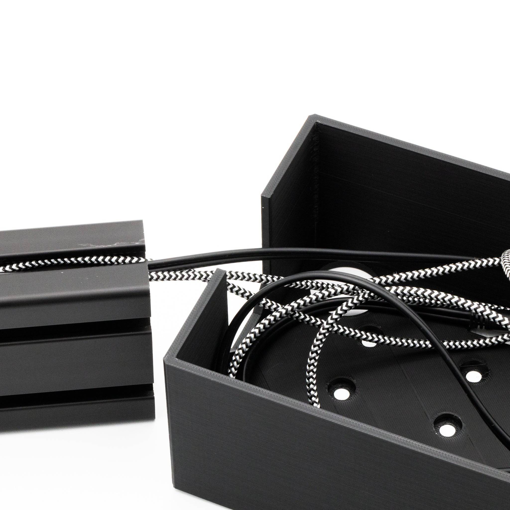 SimSportGadget cable management box for sim racing setups, helping organize and hide cables for a tidy gaming environment.