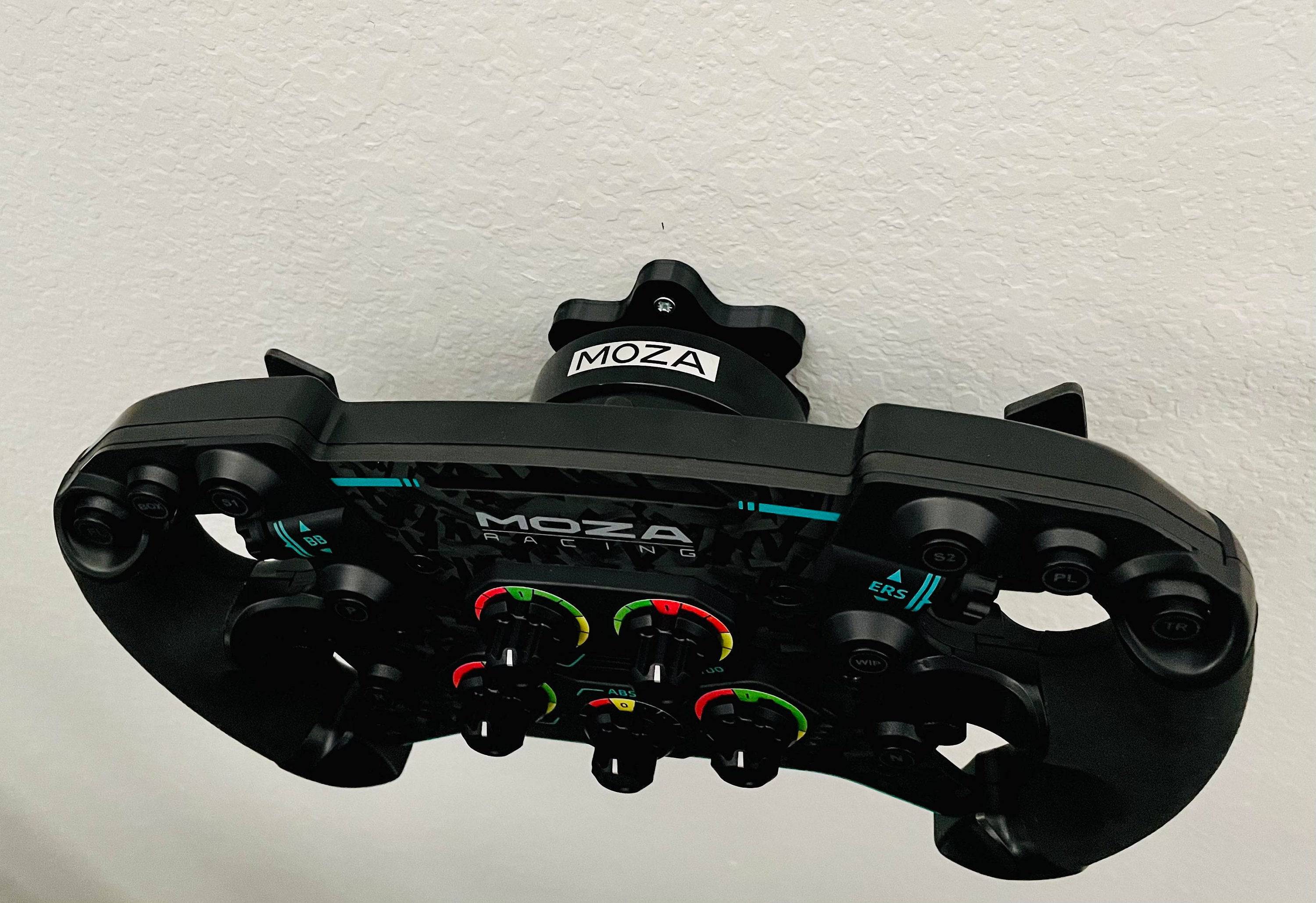 SimSportGadget wheel wall mount for Moza quick release, 360-degree adjustable angle, securely holds steering wheel setup.