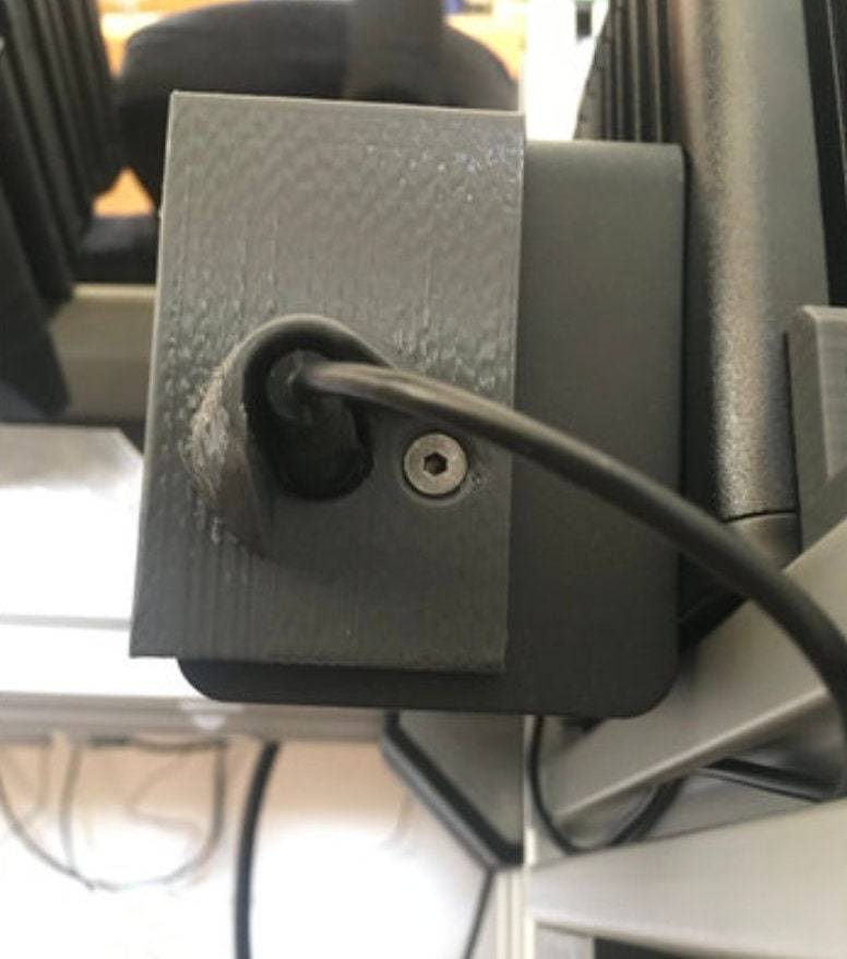 SimSportGadget Fanatec handbrake cable protector mounted on accessories mount, protecting and organizing gaming sim racing cables.