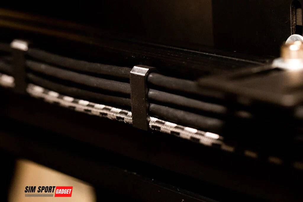 SimSportGadget knuckle cable management clip securing multiple cables neatly and securely for organized wiring solutions.