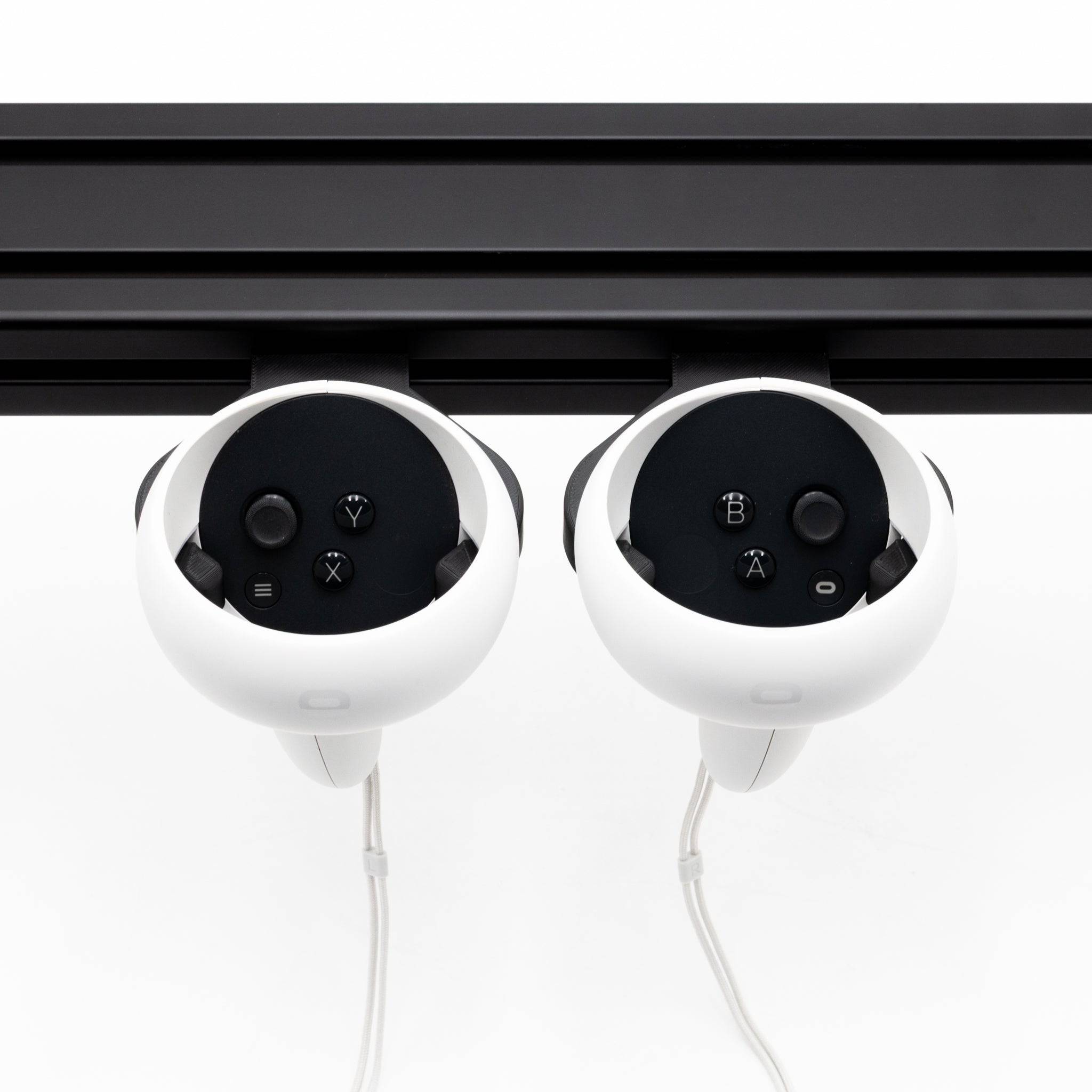 Pair of SimSportGadget Oculus Quest 2 controller mounts, black accessories holders for secure storage and easy access.
