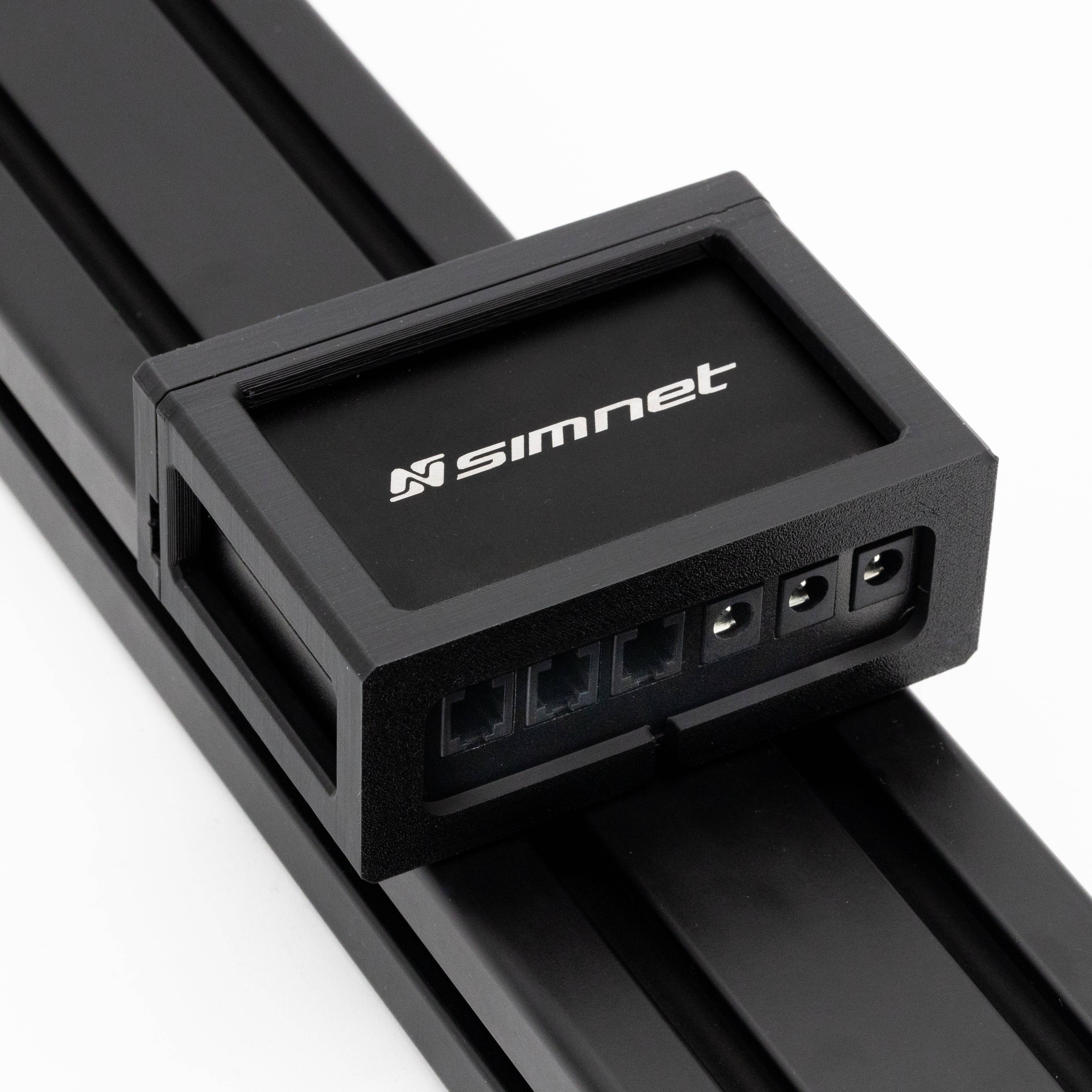 SimSportGadget SIMNET Pedal Controller Mount accessory mounted on a racing simulator setup for stable pedal placement.