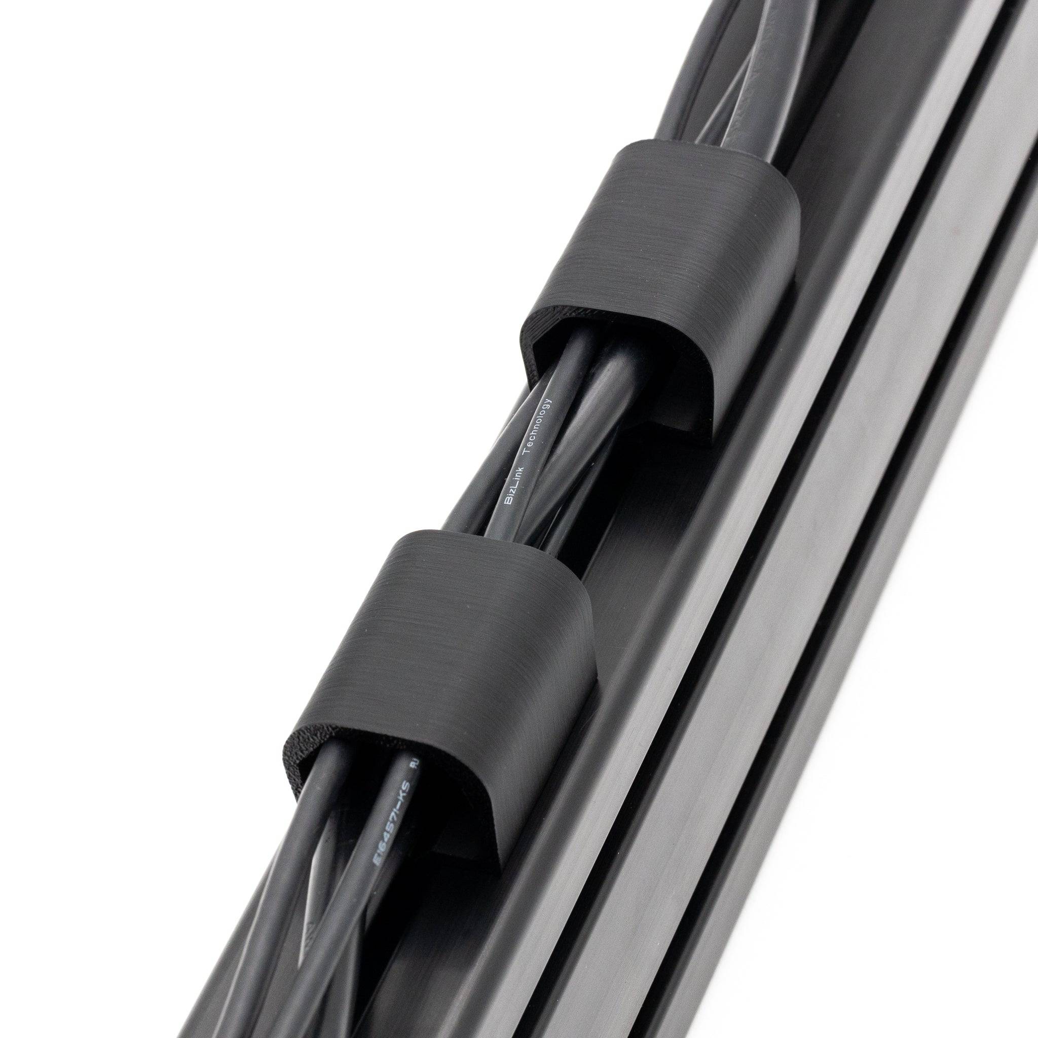 SimSportGadget cable management channel with a thick cable clip for organized, tidy cable routing and secure fastening.