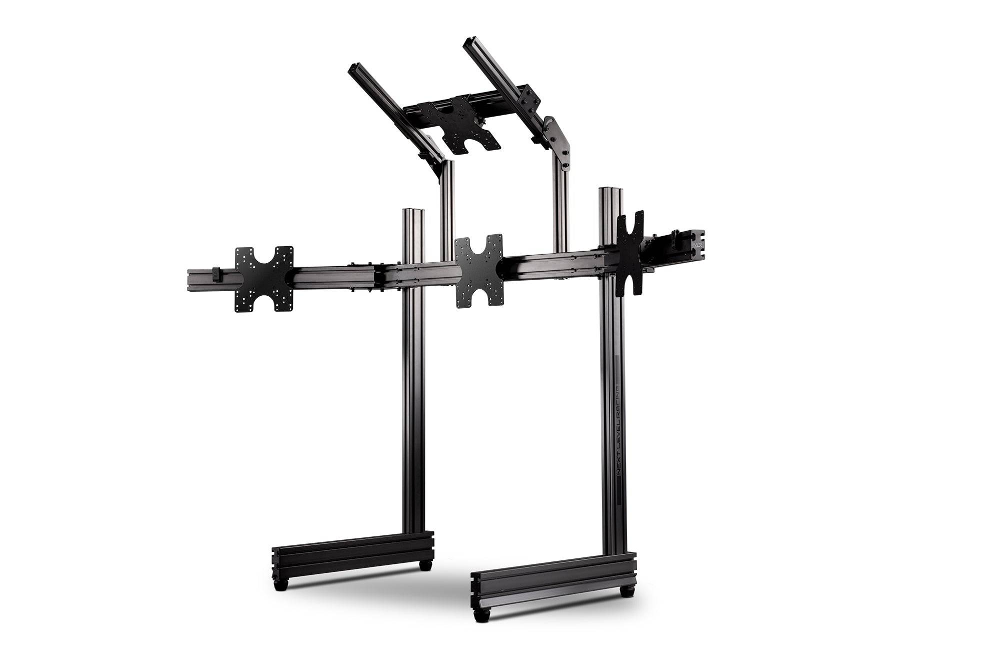 Next Level Racing Elite freestanding quad monitor stand in carbon grey holding four monitors with adjustable arms.